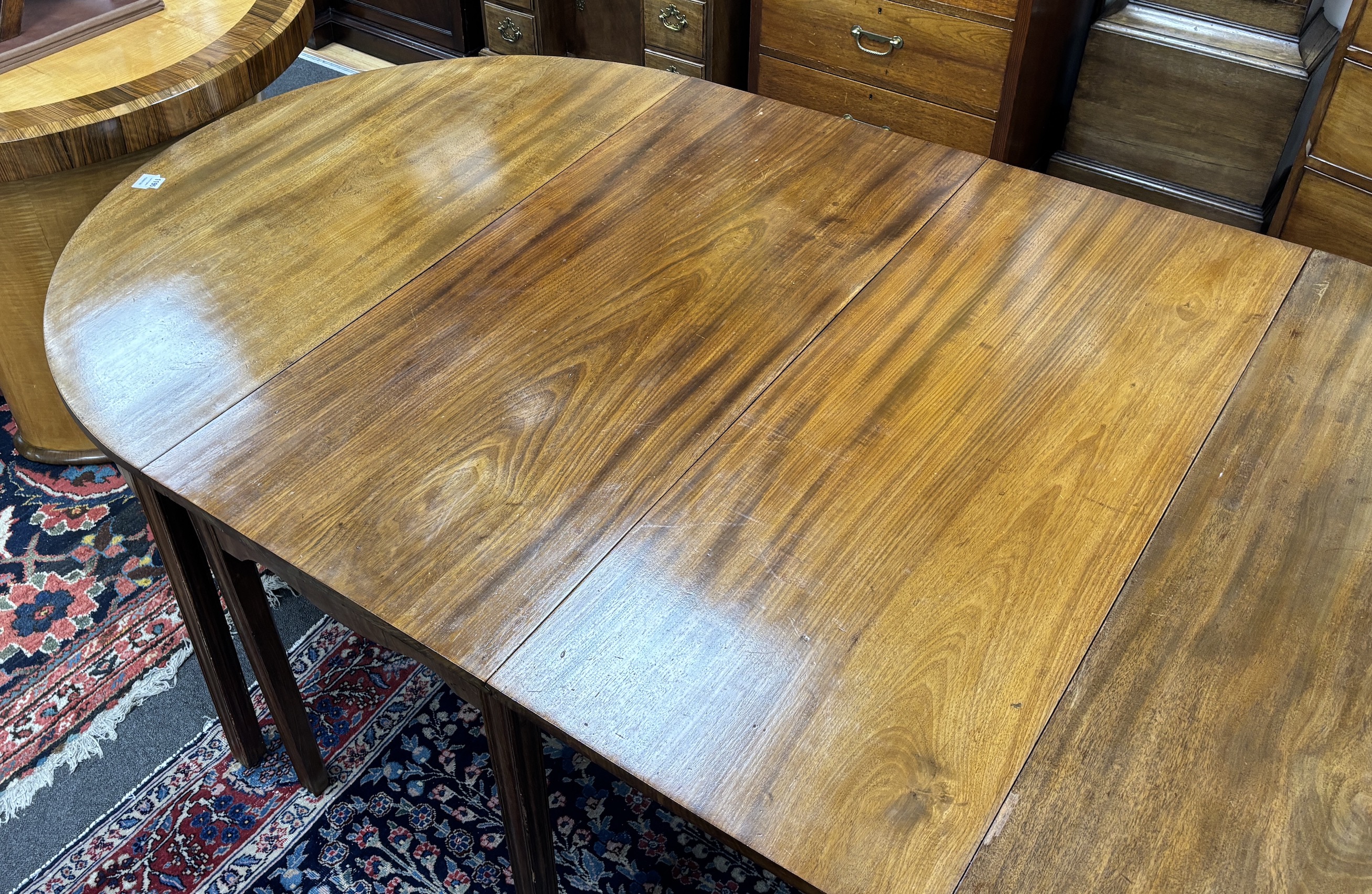 A George III mahogany D end extending dining table, 264cm extended, three spare leaves, width 121cm, height 72cm